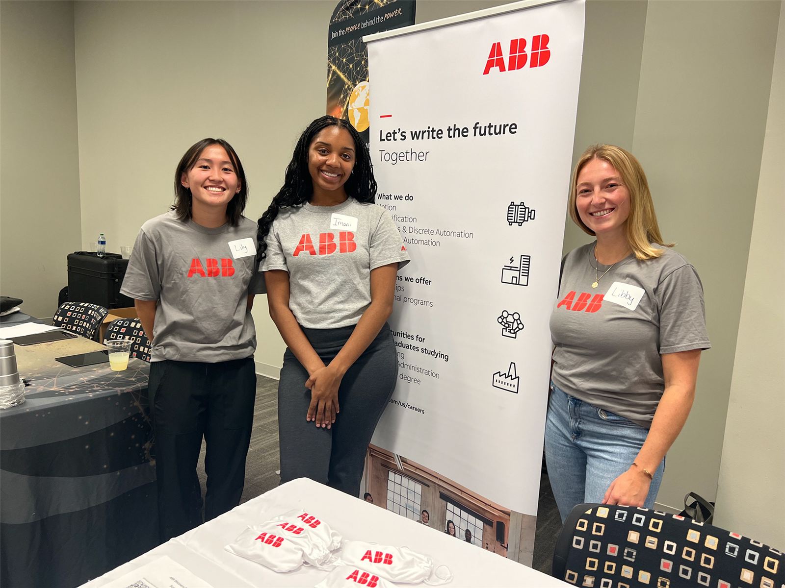 Three people at an ABB career fair booth